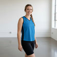 Pivotstar blue athletic jersey with black side panels and v-neck, worn by a woman with a braid.