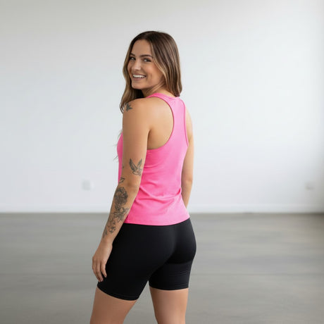 Pivotstar purple athletic Supplex jersey with racerback and fitted body, worn by a woman with tattoos.