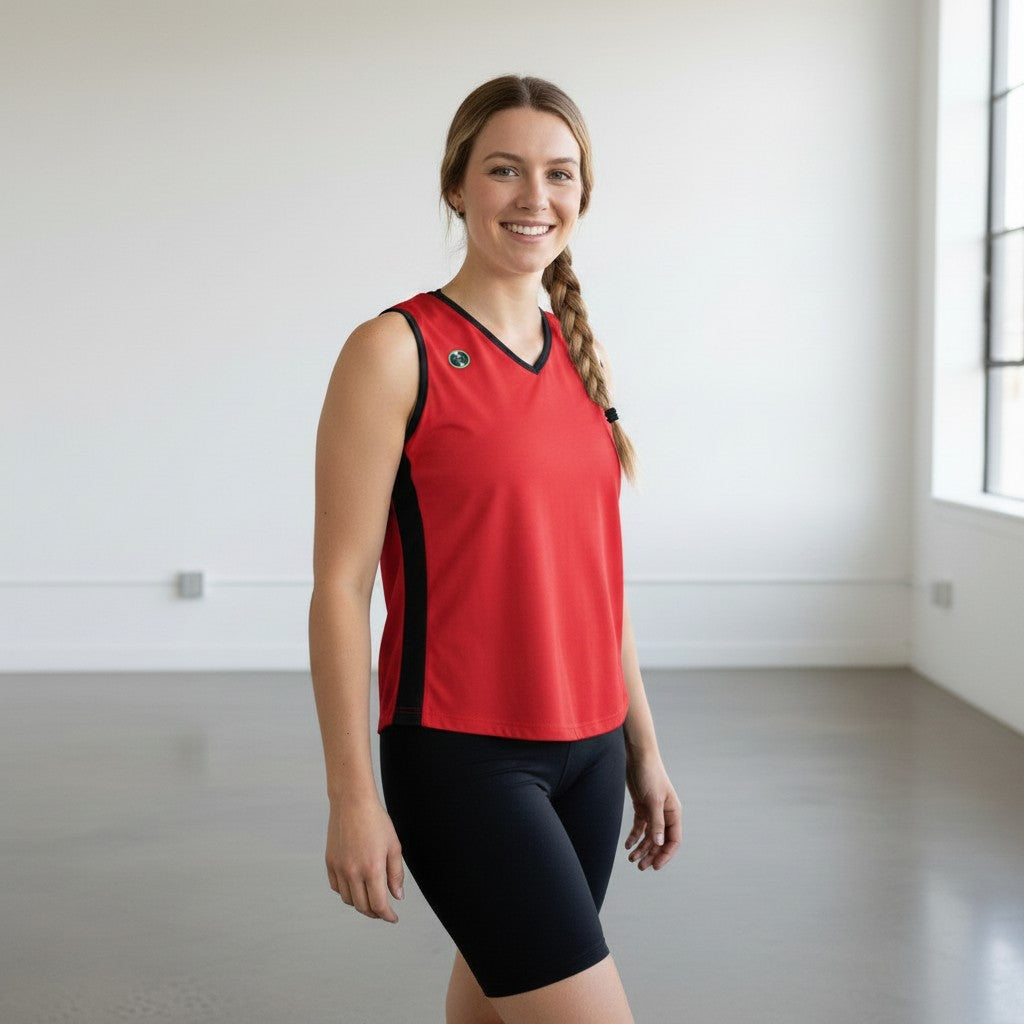Pivotstar white sport fit jersey with black side panels and v-neck, worn by a woman in black shorts.